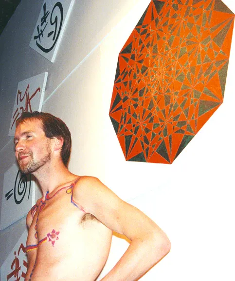 Jacob Hokanson standing in front of his piece titled: "Return of the Goddess"